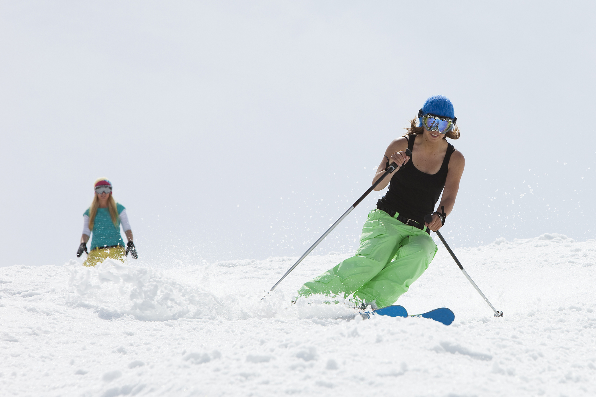 Young girls skiing together.