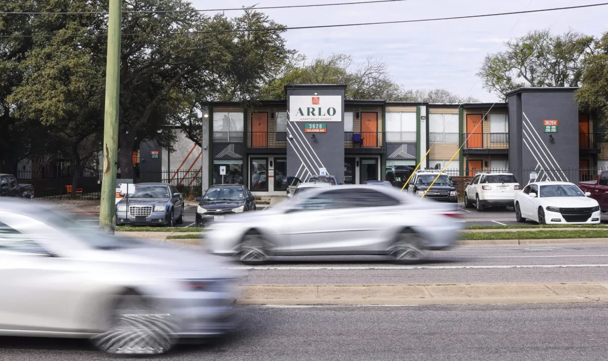 Cars pass by apartments in Dallas on March 13, 2023.. (Liesbeth Powers/The Dallas Morning News via AP)