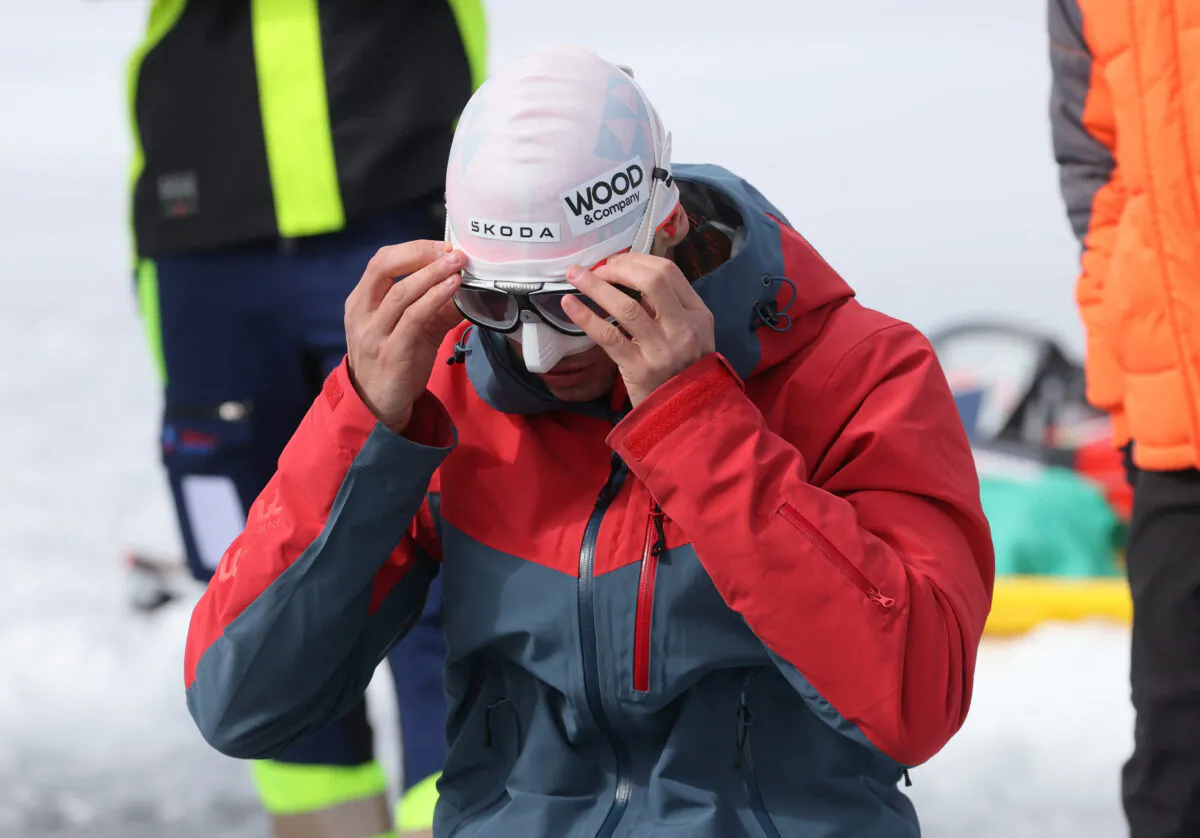 Czech freed-iver David Vencl prepares for his attempt to dive 50 meters under the ice of Lake Sils in one breath and wearing only a swimsuit in Sils near St. Moritz, Switzerland, on March 14, 2023. (Denis Balibouse/Reuters)