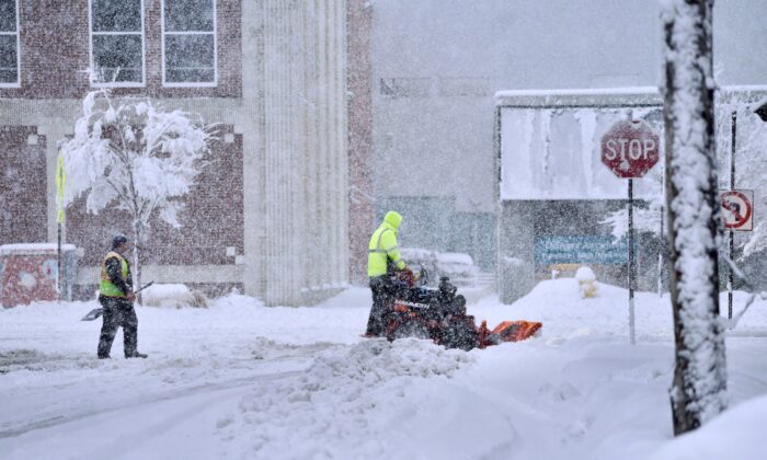A worker plows snow on a street in Pittsfield, Mass., on March 14, 2023. (Ben Garver/The Berkshire Eagle via AP)
