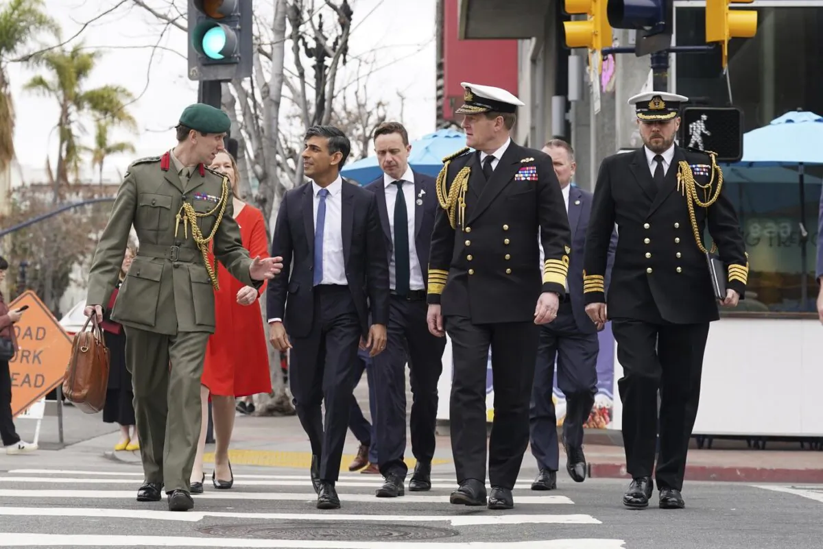 Britain's Prime Minister Rishi Sunak, left to right, Col Jaimie Norman, Admiral Sir Ben Key, First Sea Lord, and Commander Gus Carnie during Sunak's visit to San Diego, Mar. 13, 2023. (The Canadian Press/Stefan Rousseau-Pool via AP)