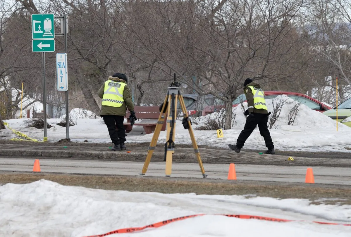 Police officers check the scene of a fatal crash in Amqui, Que., on March 14, 2023. (The Canadian Press/Jacques Boissinot)