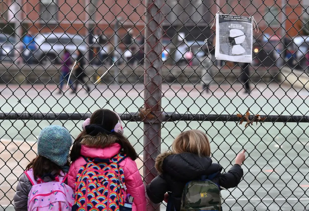 Children look at their school grounds as they wait for class on the first day of school reopening in the Brooklyn borough of New York City on Dec. 7, 2020. (Angela Weiss/AFP via Getty Images)