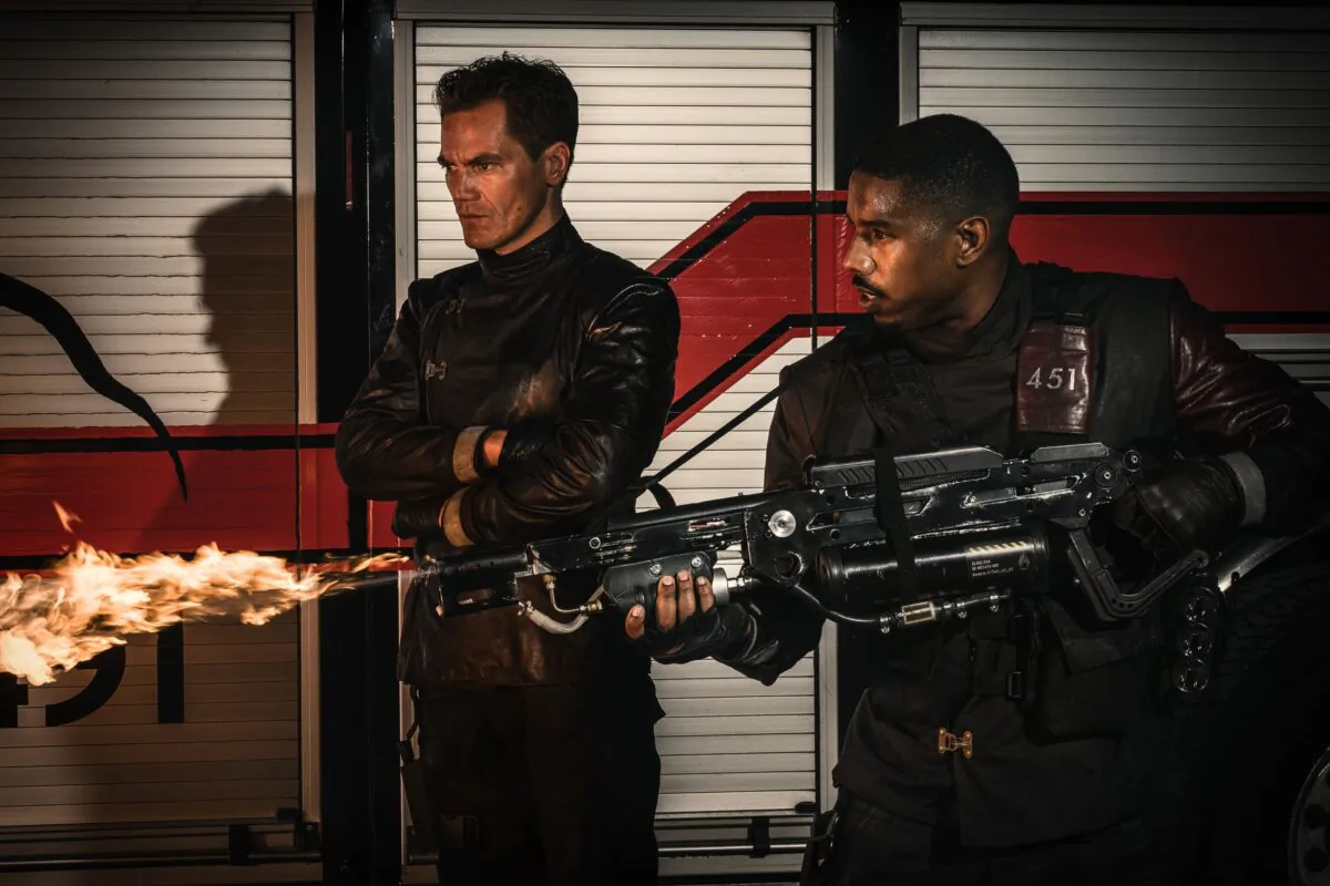 Captain John Beatty (Michael Shannon, L) and Guy Montag (Michael B. Jordan) burn books in the 2018 release of "Fahrenheit 451." (MovieStillsDB)