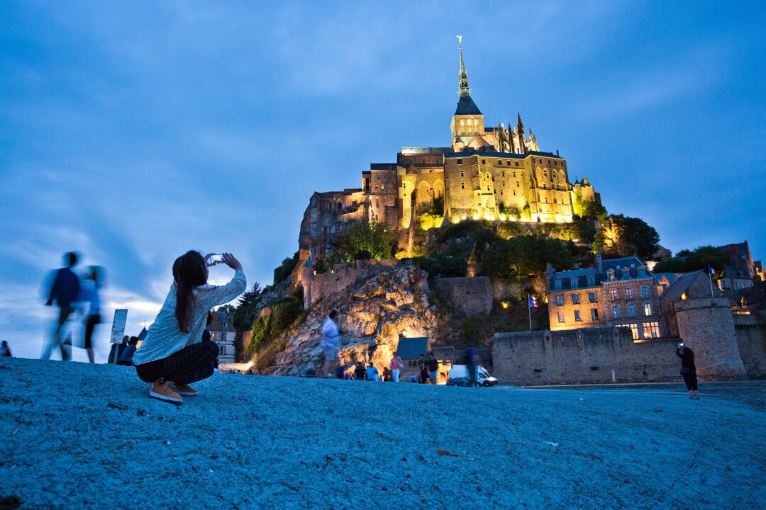 Christian pilgrims and tourists are drawn to the dramatically situated Mont St-Michel, a soaring island abbey in Normandy that is completely surrounded by the sea at high tide. (Dominic Arizona Bonuccelli)