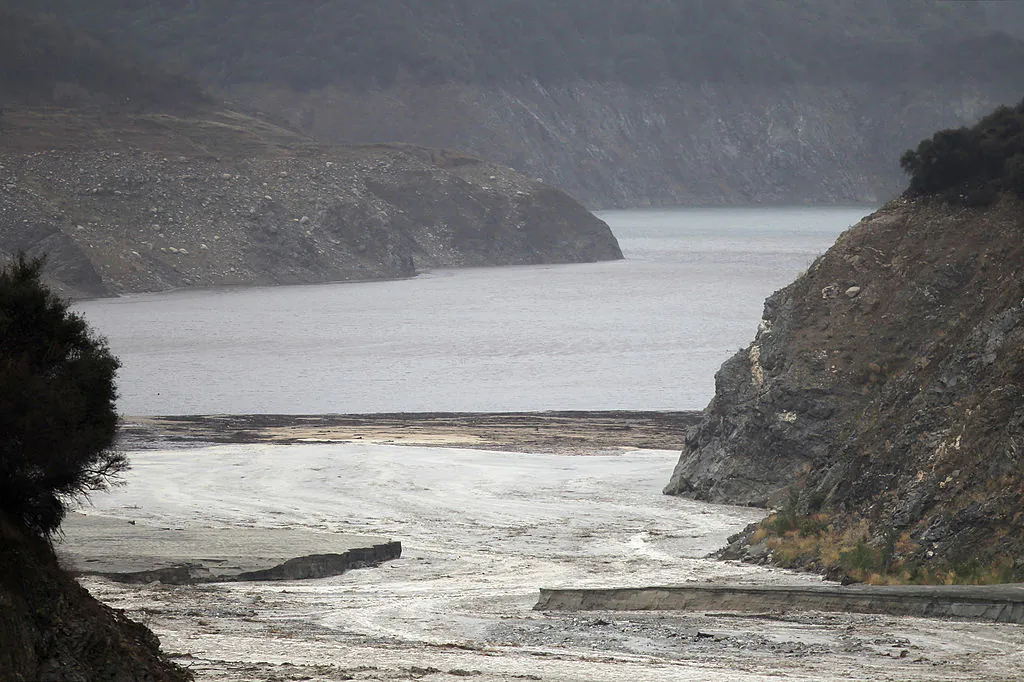 The rain-muddied San Gabriel River rushes into the upper reaches of the low waters of San Gabriel Reservoir in the Angeles National Forest as a storm brings rain in the midst of record drought near Azusa, Calif., on Feb. 28, 2014. (David McNew/Getty Images)