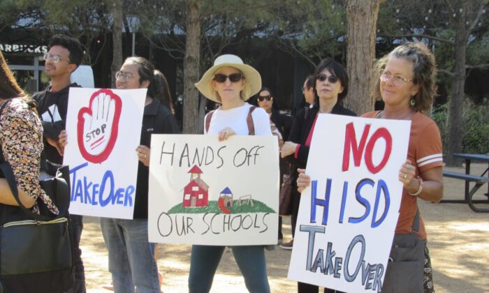 People hold up signs at a news conference in Houston, Texas, on March 3, 2023, while protesting the proposed takeover of the city's school district by the Texas Education Agency. (Juan A. Lozano/AP Photo)