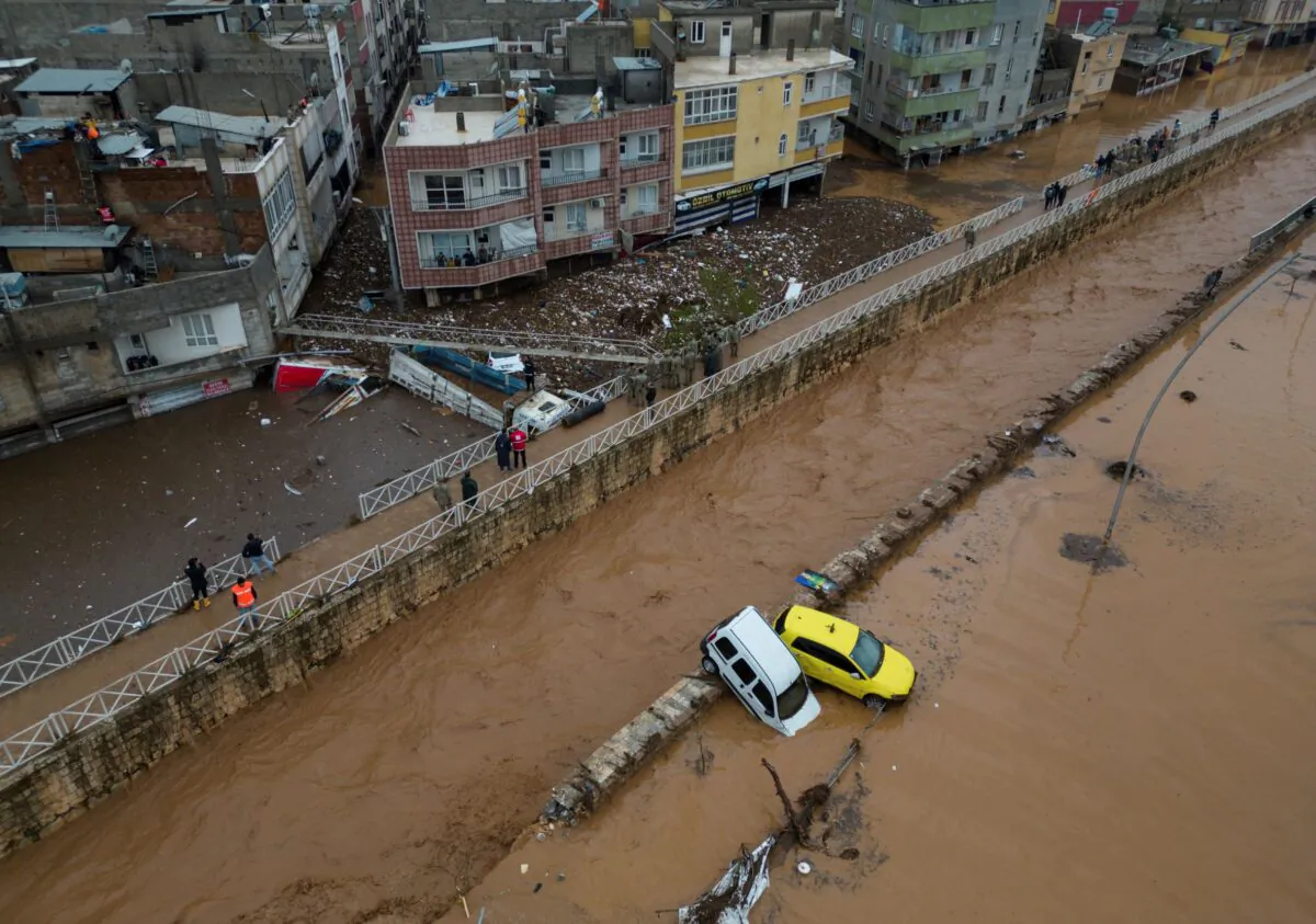 Vehicles and debris are scattered during floods after heavy rains in Sanliurfa, Turkey, on March 15, 2023. (Hakan Akgun/DIA via AP)