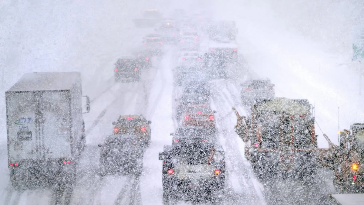 Plows, at right, try to pass nearly stopped traffic, due to weather conditions, on Route 93 South, in Londonderry, N.H., on March 14, 2023. (Charles Krupa/AP Photo)
