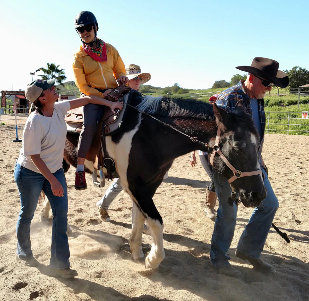 A student rides a horse guided by staff members at Ride Above Disability Therapeutic Riding Center in Poway, Calif. (Courtesy of the Office of San Diego County Supervisor Joel Anderson)