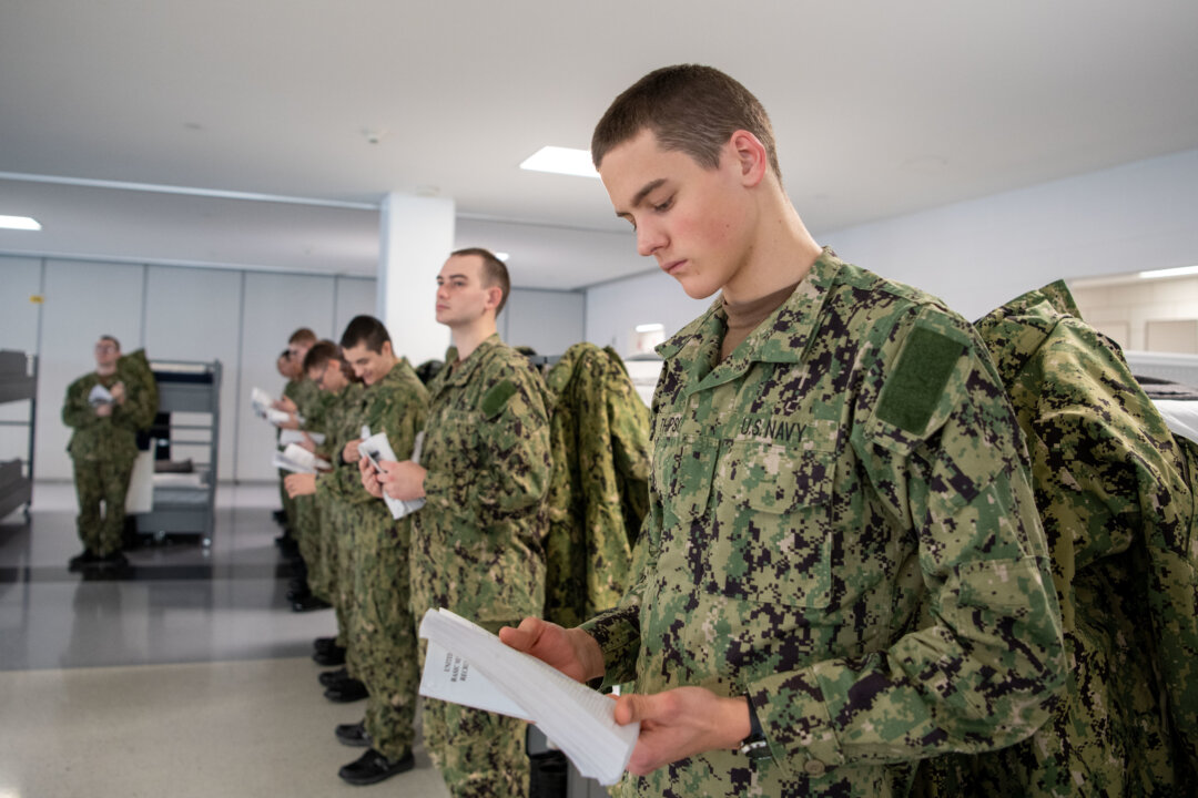 Recruits read their Recruit Training Guide for Basic Military Training in a compartment of the USS Hopper at Recruit Training Command, Great Lakes, Illinois. More than 40,000 recruits train annually at the Navy's only boot camp. (U.S. Navy photo by Mass Communication Specialist 1st Class Stephane Belcher)