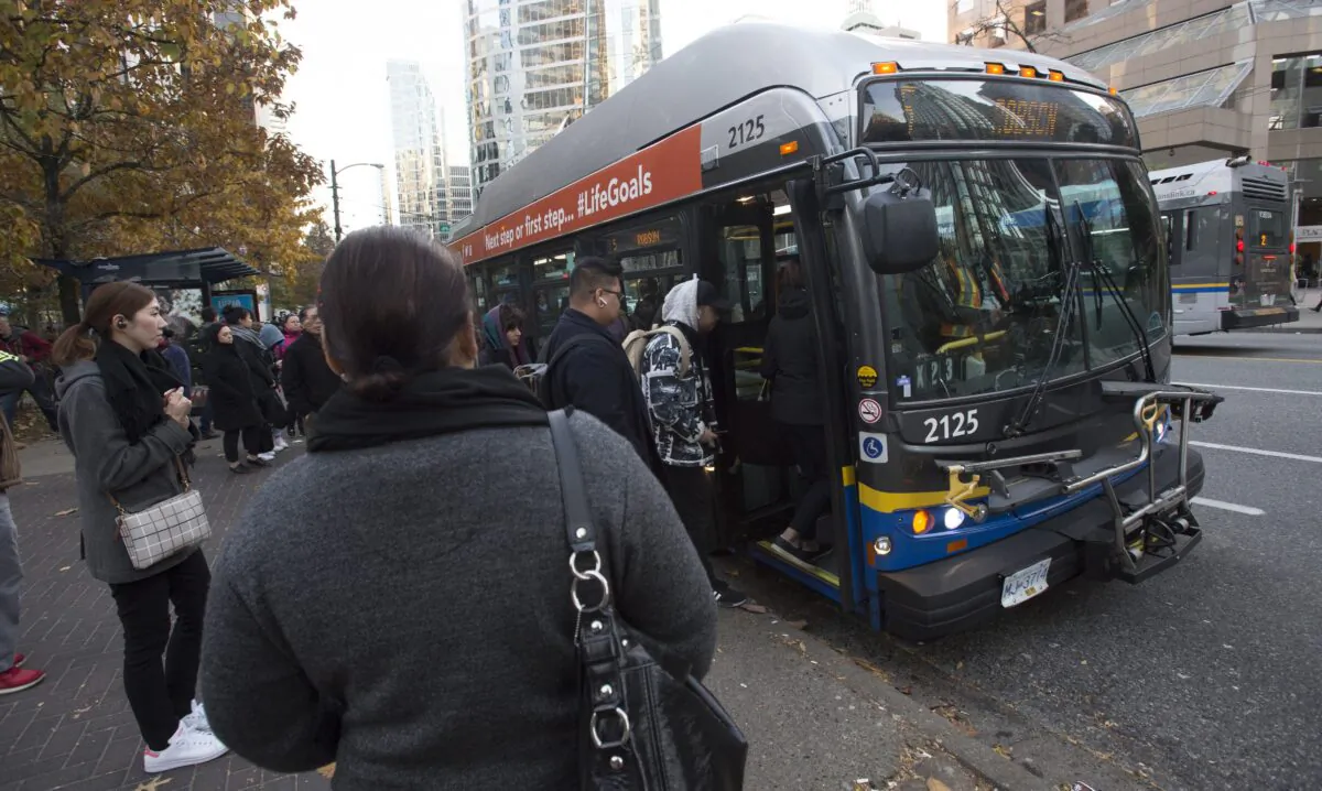 Passengers board a bus in downtown Vancouver on Nov. 1, 2019. (The Canadian Press/Jonathan Hayward)