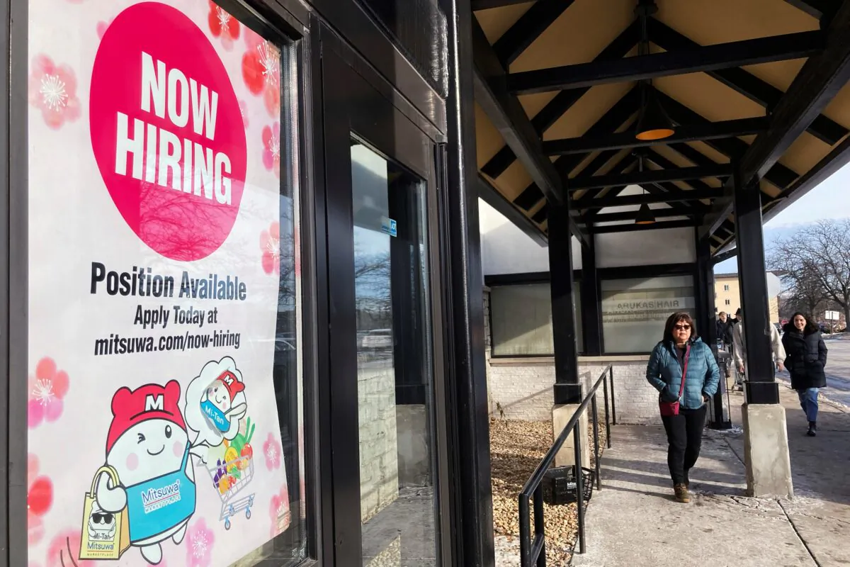 A hiring sign at a grocery store in Arlington Heights, Ill., on Dec. 27, 2022. (Nam Y. Huh/AP Photo)