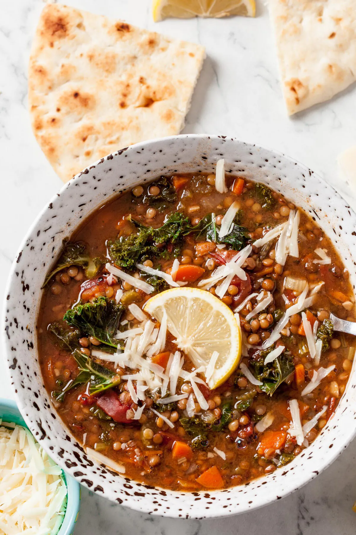 Serve vegan lentil soup topped with a lemon wedge and Parmesan cheese. (Courtesy of Amy Dong)
