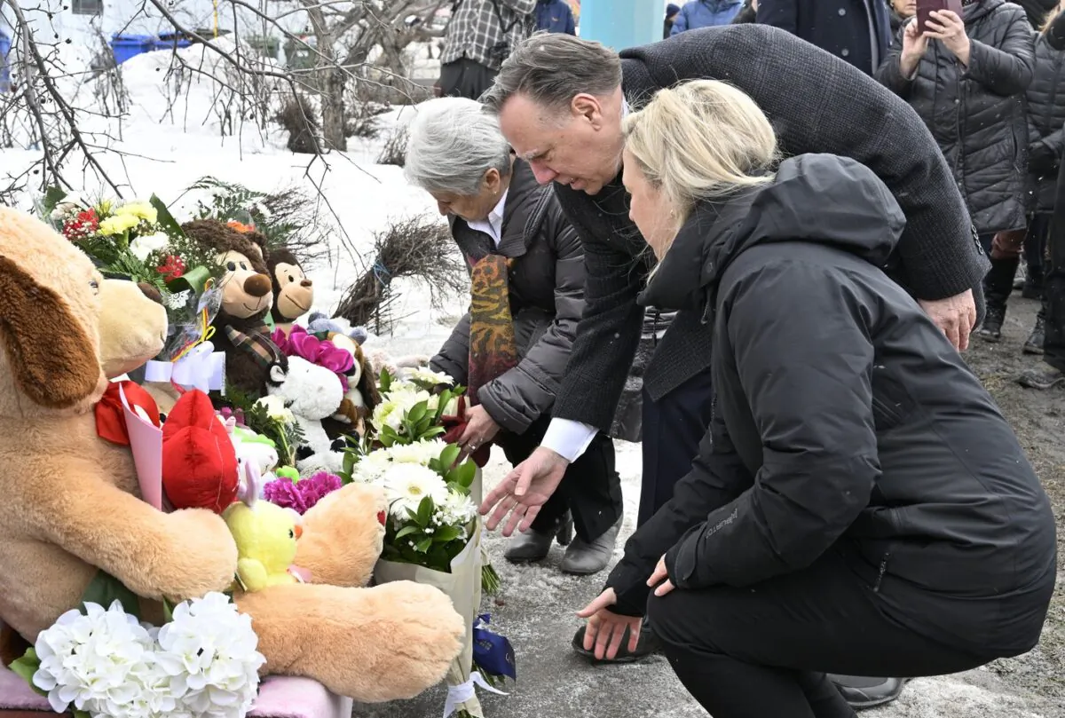 Quebec Premier Francois Legault sets flowers at a memorial for the victims, in Amqui, Que., on March 16, 2023. (The Canadian Press/Jacques Boissinot)