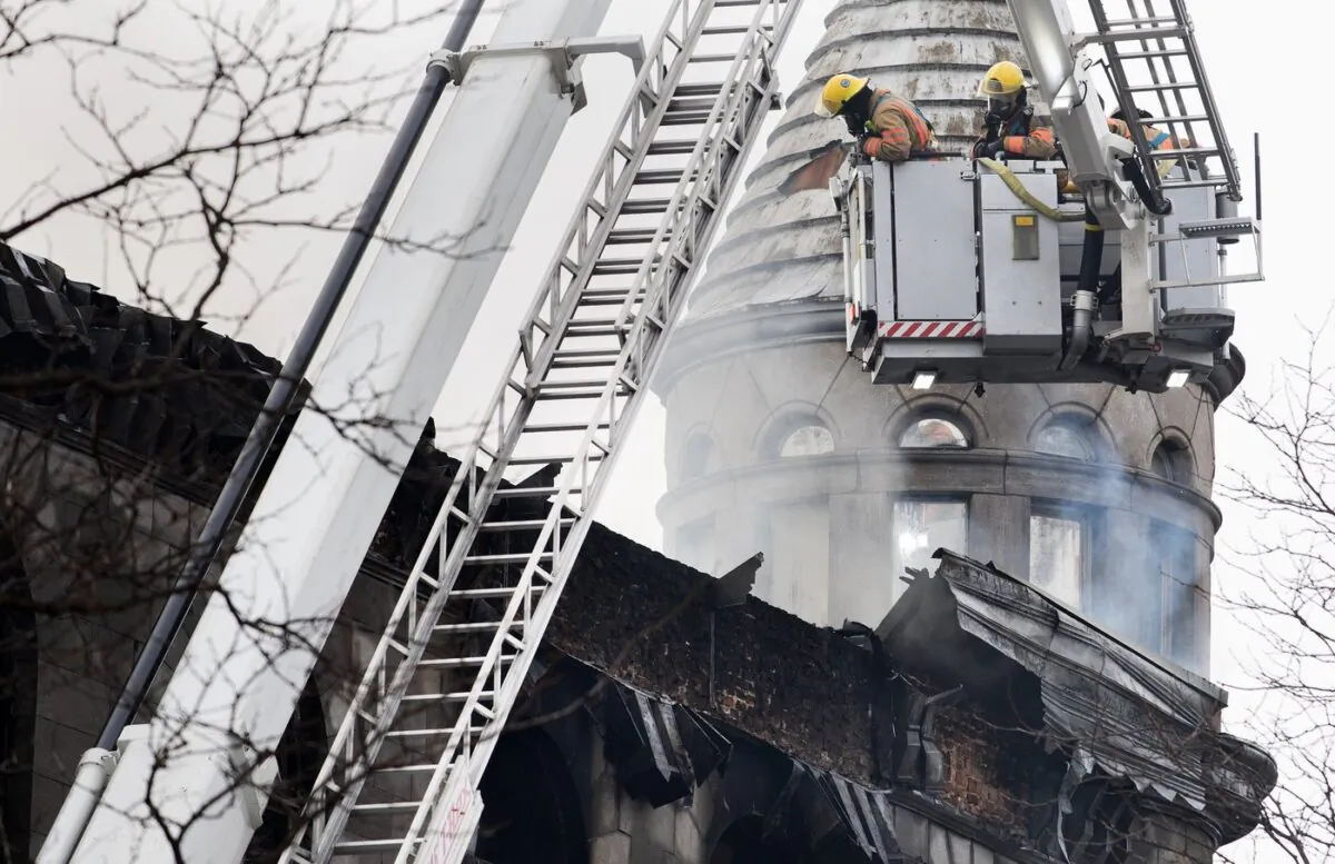 Firefighters survey the scene of a fire in Old Montreal on March 16, 2023. (The Canadian Press/Graham Hughes)