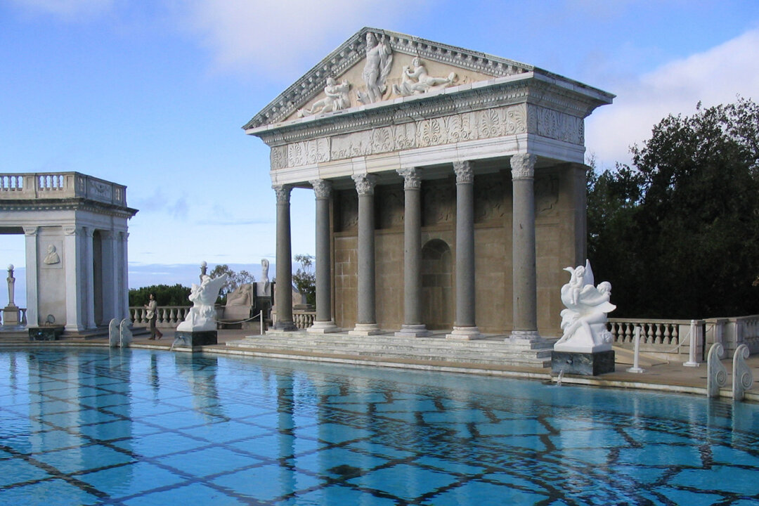 The Hearst Castle, designed by architect Julia Morgan for William Randolph Hearst, is known for its opulent exterior Neptune Pool and its warm mountain spring waters. (Donald R. Neudecker/Shutterstock)