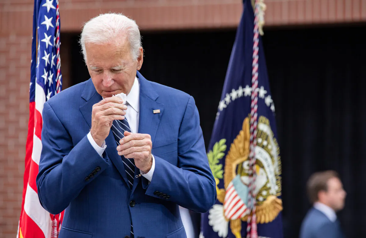 President Joe Biden sneezes in irvine, Calif., on Oct. 14, 2022. (John Fredricks/The Epoch Times)