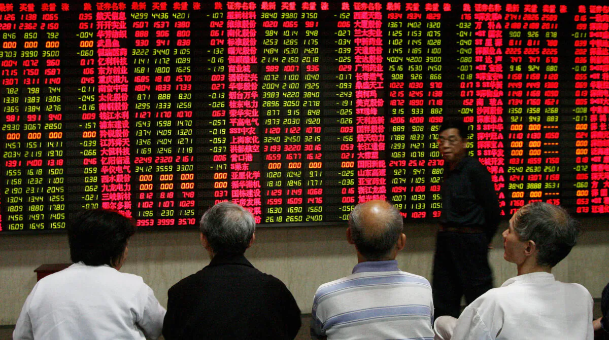 Elderly Chinese investors watch a stock price board at a private securities firm in Shanghai on May 9, 2007. (Mark Ralston/AFP via Getty Images)