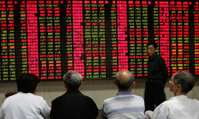 Elderly Chinese investors watch a stock price board at a private securities firm in Shanghai on May 9, 2007. (Mark Ralston/AFP via Getty Images)