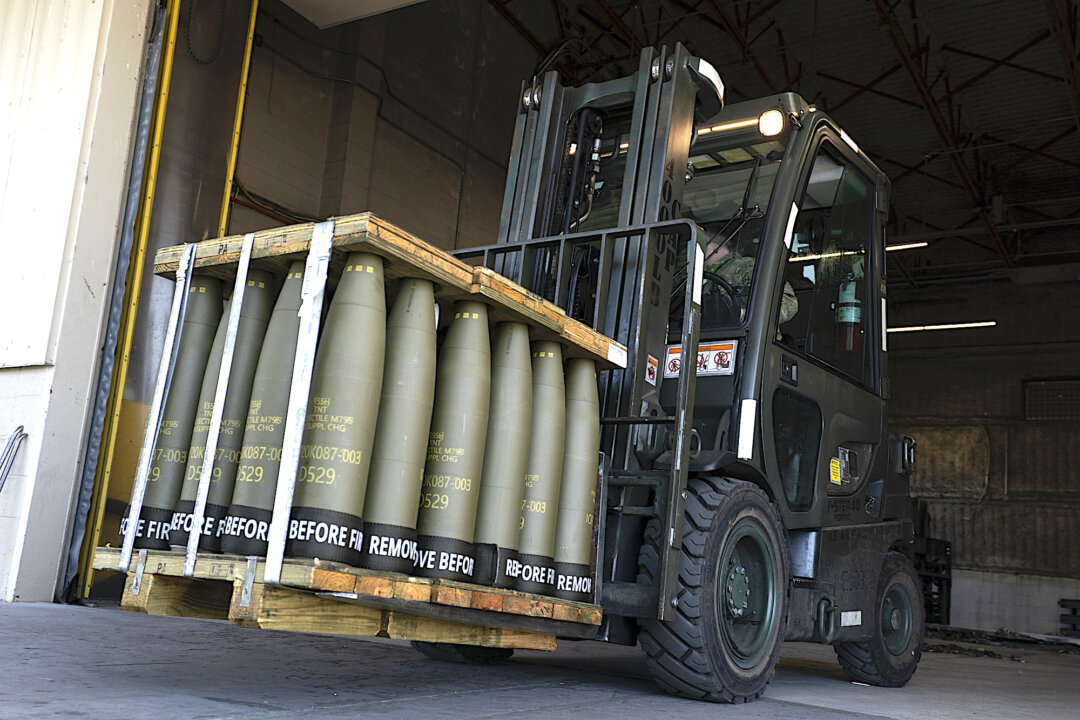 Airmen with the 436th Aerial Port Squadron use a forklift to move 155 mm shells ultimately bound for Ukraine, at Dover Air Force Base, Del., April 29, 2022. (AP Photo/Alex Brandon)