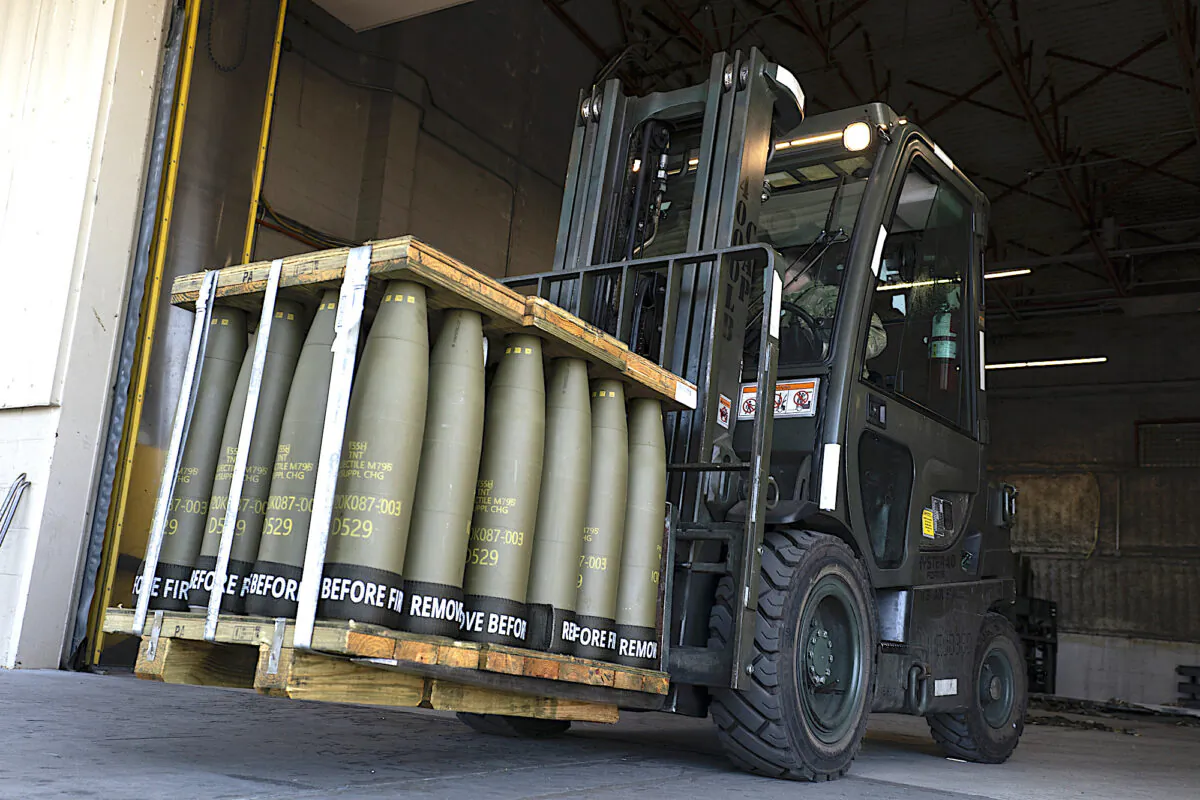 Airmen with the 436th Aerial Port Squadron use a forklift to move 155 mm shells ultimately bound for Ukraine, at Dover Air Force Base, Del., April 29, 2022. (AP Photo/Alex Brandon)