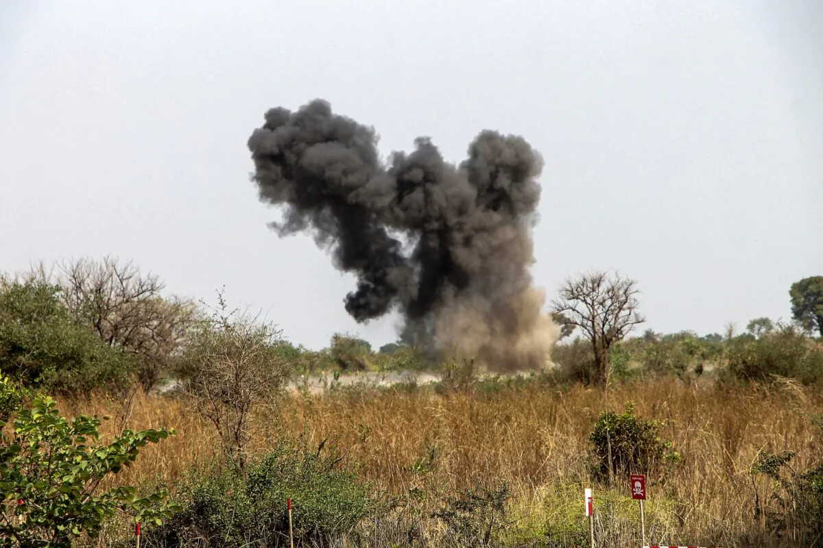 A cloud of smoke billows above the site of a controlled detonation of land mines by experts from the United Nations Mine Action Service (UNMAS) following a demining exercise of a field rigged up during the civil war at Gondokoro village in the capital Juba, South Sudan, on Jan. 26, 2022. (AFP via Getty Images)