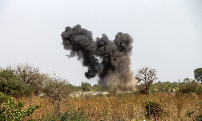 A cloud of smoke over the site of a controlled detonation of a mine by United Nations Mine Clearance Service (UNMAS) experts after a demining exercise of a mine rigged during the civil war in the village of Gondokoro in Juba, the capital of South Sudan swells, January 26, 2022.  (AFP via Getty Images)