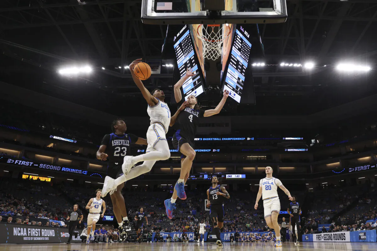 Abramo Canka #1 of the UCLA Bruins shoots a layup under Drew Pember #4 of the North Carolina-Asheville Bulldogs during the second half in the first round of the NCAA Men's Basketball Tournament at Golden 1 Center in Sacramento, Calif., on March 16, 2023. (Ezra Shaw/Getty Images)