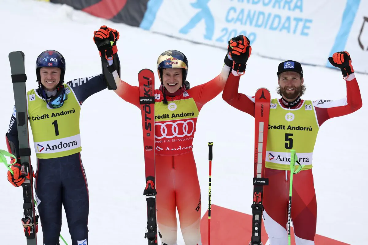 Switzerland's Marco Odermatt (C), winner of an alpine ski, men's World Cup giant slalom race, celebrates with second-placed Norway's Henrik Kristoffersen (L) and third-placed Austria's Marco Schwarz, in Soldeu, Andorra, on March 18, 2023. (Alessandro Trovati/AP Photo)