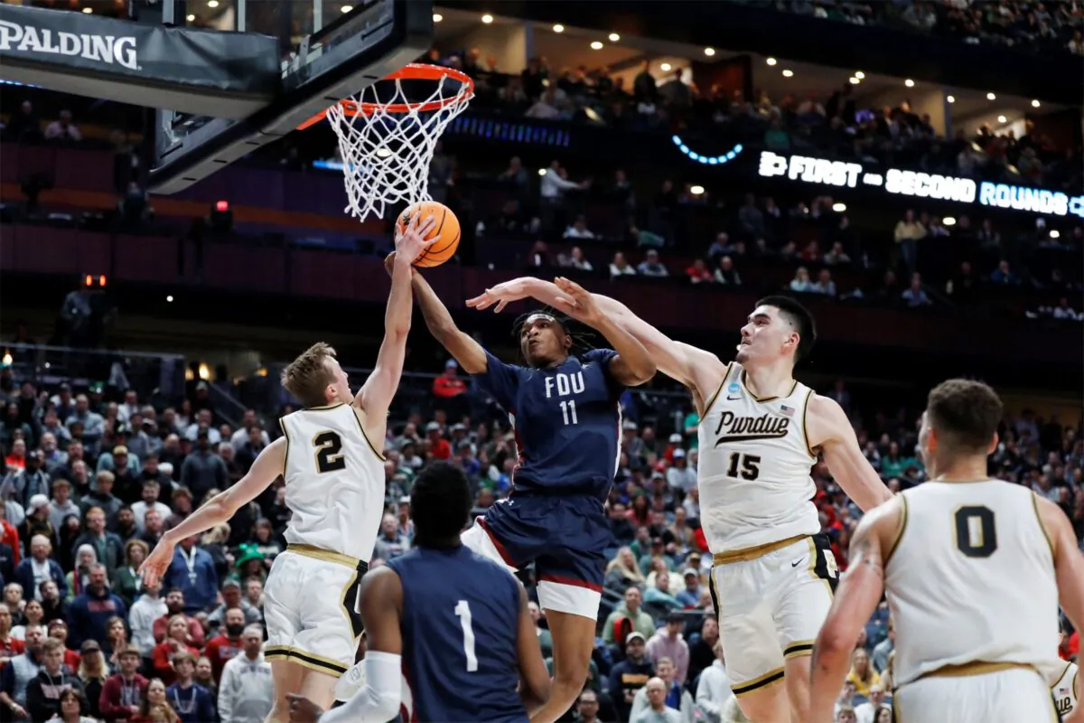 Purdue Boilermakers guard Fletcher Loyer (2) blocks a shot from Fairleigh Dickinson Knights forward Sean Moore (11) in the second half at Nationwide Arena in Columbus, Ohio, on March 17, 2023. (Joseph Maiorana/USA TODAY Sports via Reuters)