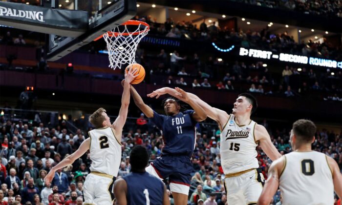 Purdue Boilermakers guard Fletcher Loyer (2) blocks a shot from Fairleigh Dickinson Knights forward Sean Moore (11) in the second half at Nationwide Arena in Columbus, Ohio, on March 17, 2023. (Joseph Maiorana/USA TODAY Sports via Reuters)