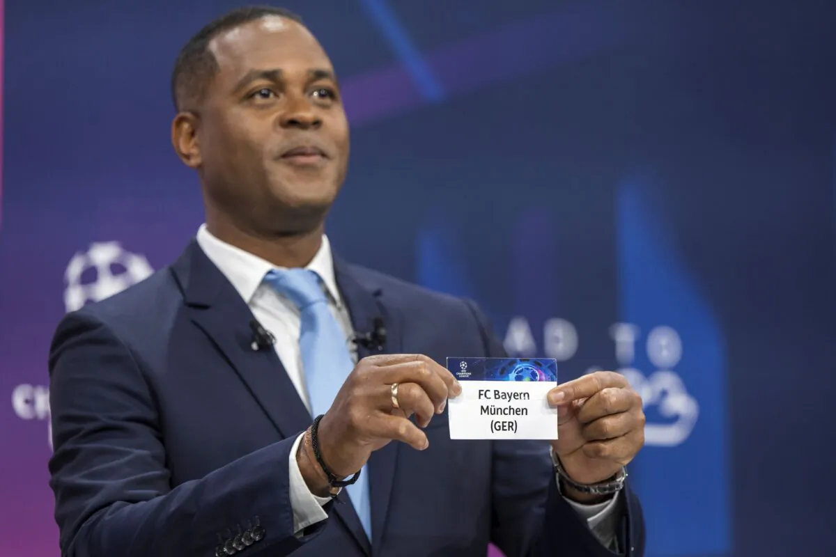 Dutch soccer player and ambassador for the UEFA Champions League final in Istanbul Patrick Kluivert shows a ticket of soccer club FC Bayern Munich during the draw for the UEFA soccer Champions League quarter-finals at the UEFA Headquarters in Nyon, Switzerland, on March 17, 2023. (Martial Trezzini/Keystone via AP)
