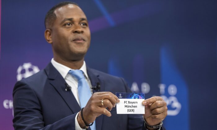 Dutch soccer player and ambassador for the UEFA Champions League final in Istanbul Patrick Kluivert shows a ticket of soccer club FC Bayern Munich during the draw for the UEFA soccer Champions League quarter-finals at the UEFA Headquarters in Nyon, Switzerland, on March 17, 2023. (Martial Trezzini/Keystone via AP)