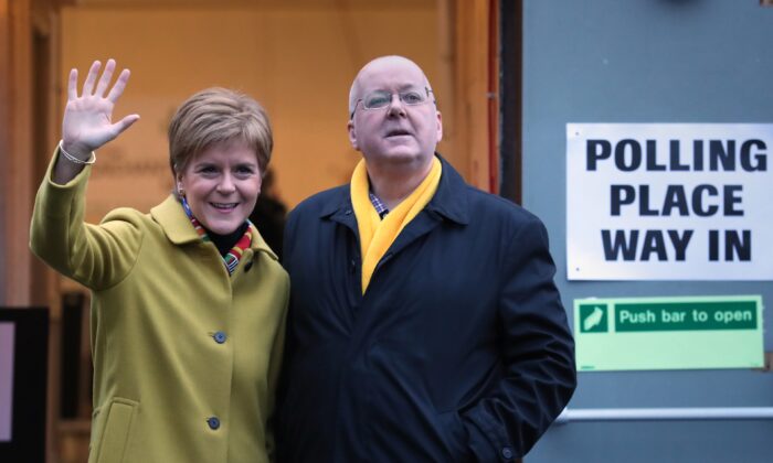 SNP leader Nicola Sturgeon and husband Peter Murrell pose after casting their votes in the 2019 General Election at Broomhouse Park Community Hall, Glasgow, Scotland, on Dec. 12, 2019. (Andrew Milligan/PA Media)