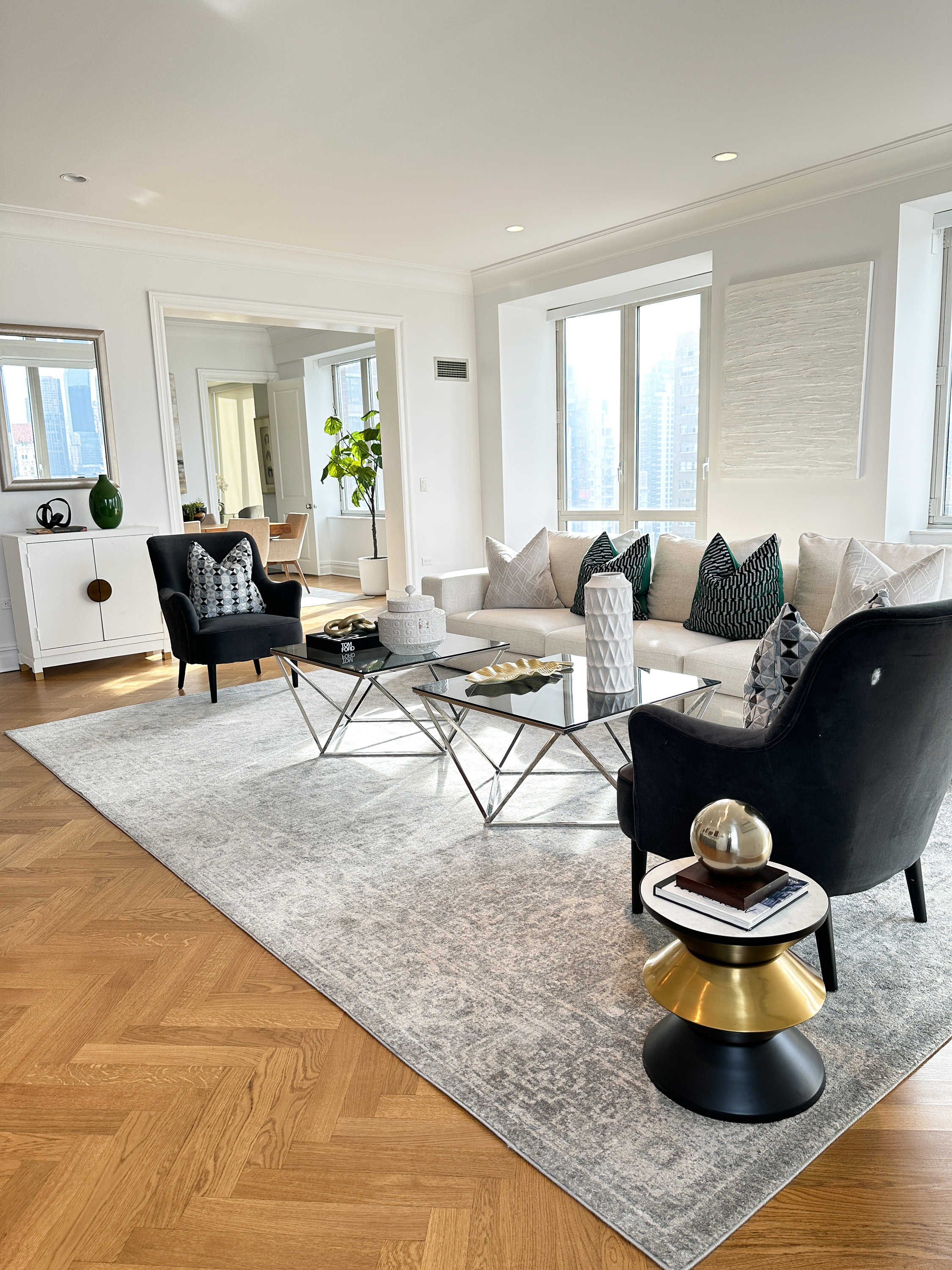 Elements of black, white and gold are repeated throughout this living room to create a sense of cohesion. 
