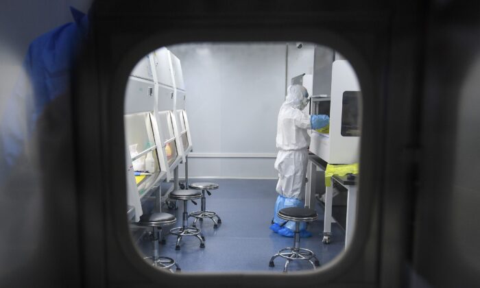 A laboratory technician working on samples from people to be tested for the new coronavirus in Wuhan in China's central Hubei province on Feb. 6, 2020. (STR/AFP via Getty Images)