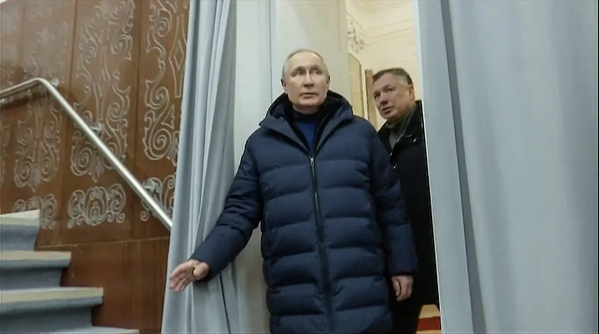 President Vladimir Putin, escorted by Deputy Prime Minister Marat Khusnullin, visits a theatre in Mariupol in Russian-controlled Donetsk region, in a still from a video released on March 19, 2023. (Russian TV Pool via AP)