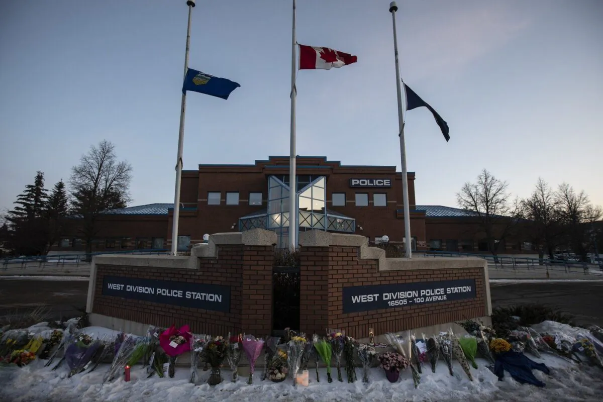 Flowers lie outside a police station for Const. Brett Ryan and Const. (The Canadian Press/Jason Franson)