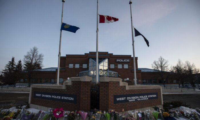 Flowers lie outside a police station for Const. Brett Ryan and Const. (The Canadian Press/Jason Franson)
