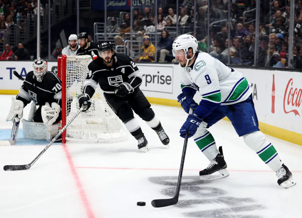 Miller (9) of the Vancouver Canucks controls the puck in front of Phillip Danault (24) and Joonas Korpisalo (70) of the Los Angeles Kings during the third period in a 3-2 Canucks overtime shootout win at Crypto.com Arena on March 18, 2023 in Los Angeles, California. (Photo by Harry How/Getty Images)