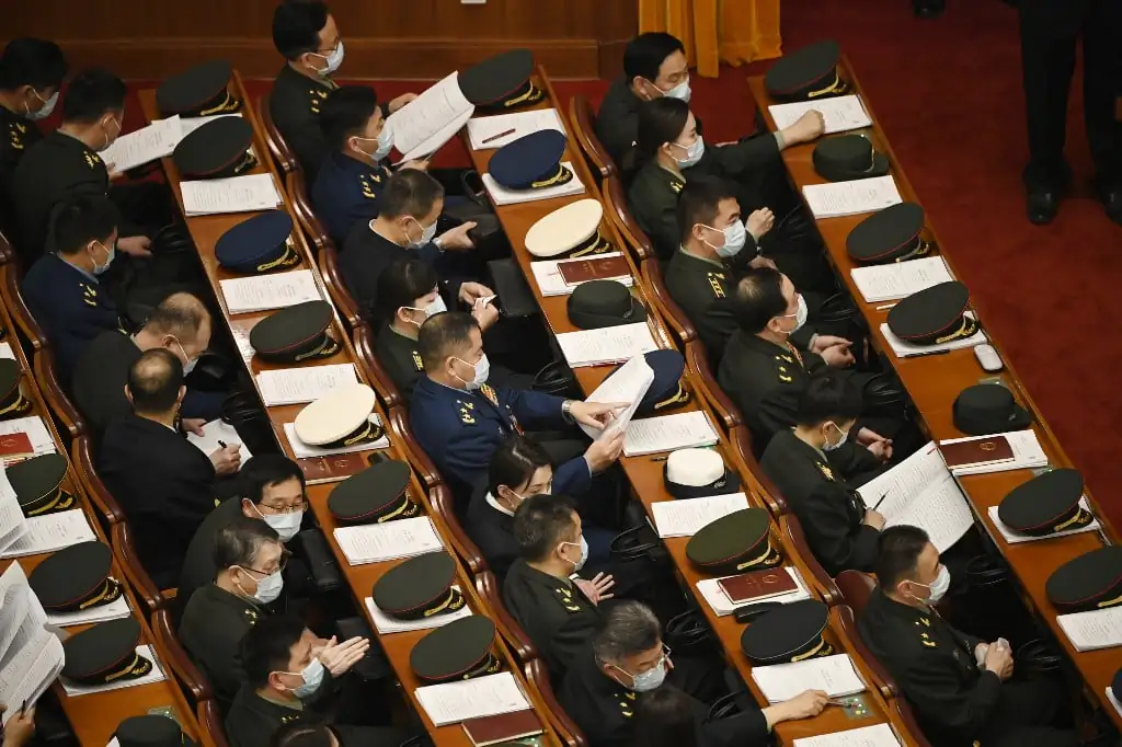 Military delegates arrive for the Two Sessions in Beijing on March 7, 2023. (Greg Baker/AFP/Getty Images)