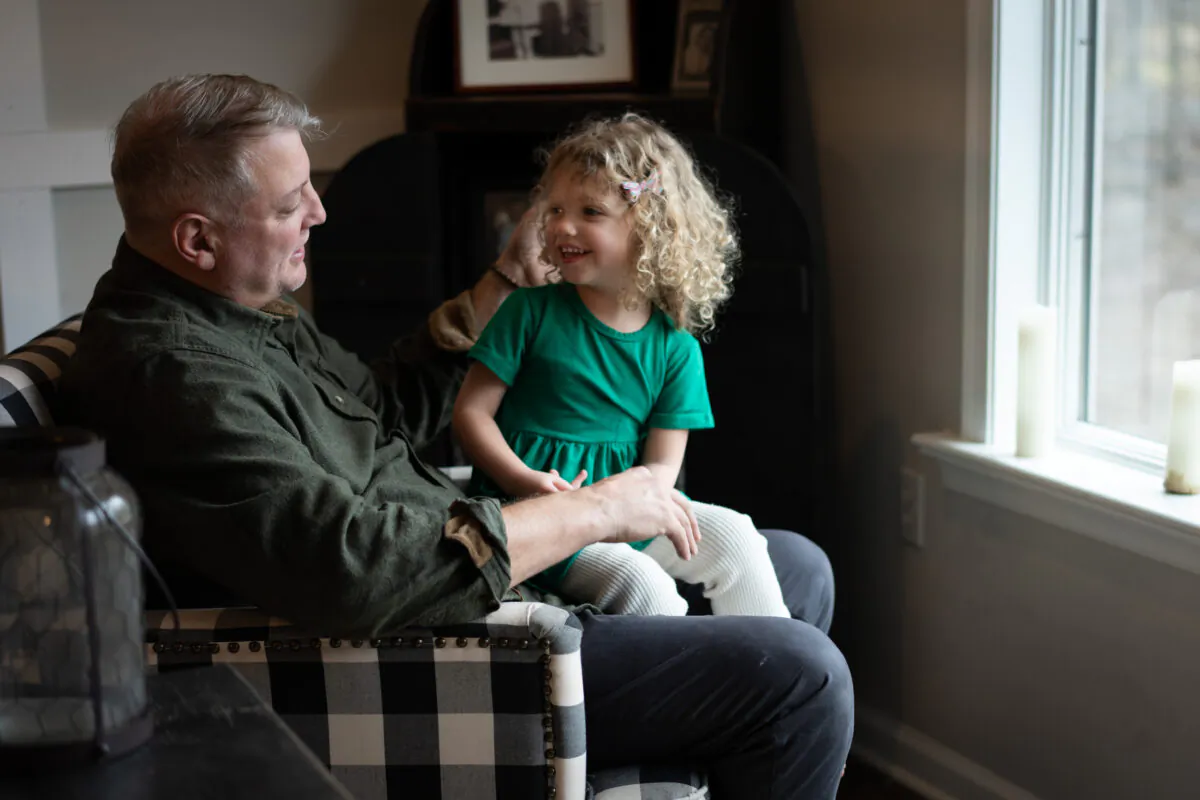 Mark Houck with his daughter, Imelda, at their home in Kintnersville, Pa., on March 17, 2023. (Samira Bouaou/The Epoch Times)