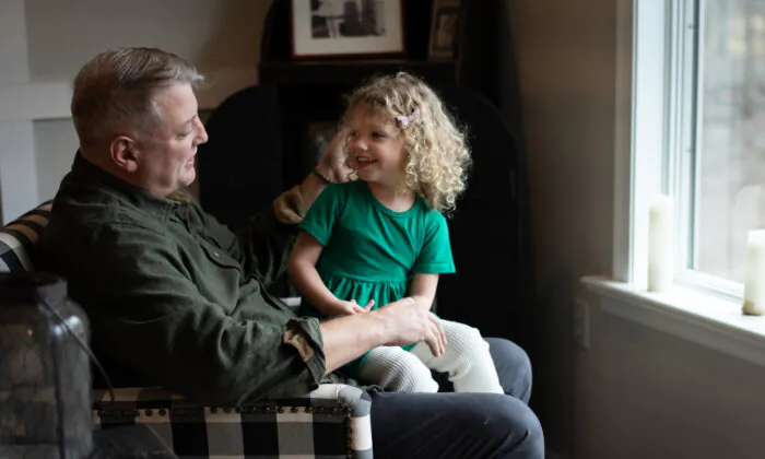 Mark Houck with his daughter, Imelda, at their home in Kintnersville, Pa., on March 17, 2023. (Samira Bouaou/The Epoch Times)