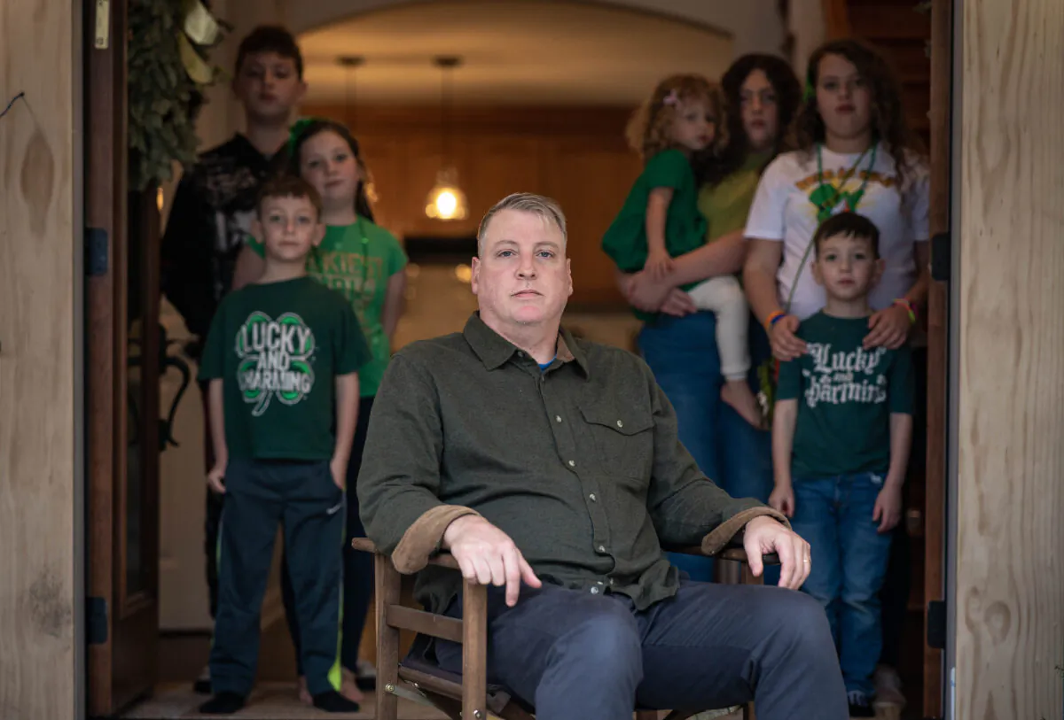Mark Houck with his seven children, (L–R) Joshua, Therese, Mark Jr., Imelda, Ava, Kathryn, and Augustine, at their home in Kintnersville, Pa., on March 17, 2023. (Samira Bouaou/The Epoch Times)