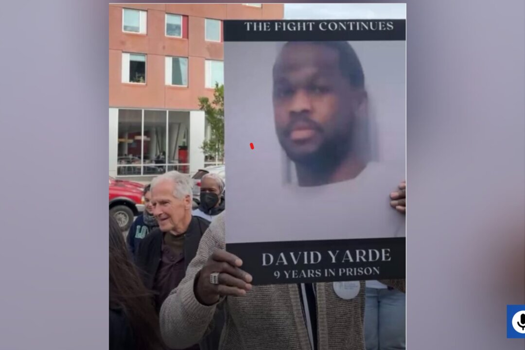 An Exoneree holds up the image of David Yarde during the Wrongful Conviction Day Rally in front of the Boston Police Headquarters in Boston, Mass. in October 2022. (Courtesy of Osagie Okoruwa)