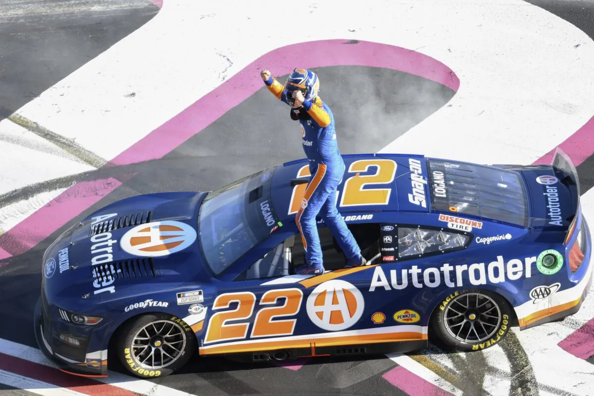 Joey Logano stands on his car after winning the NASCAR Cup Series auto race at Atlanta Motor Speedway in Hampton, Ga., on March 19, 2023. (Hakim Wright Sr./AP Photo)