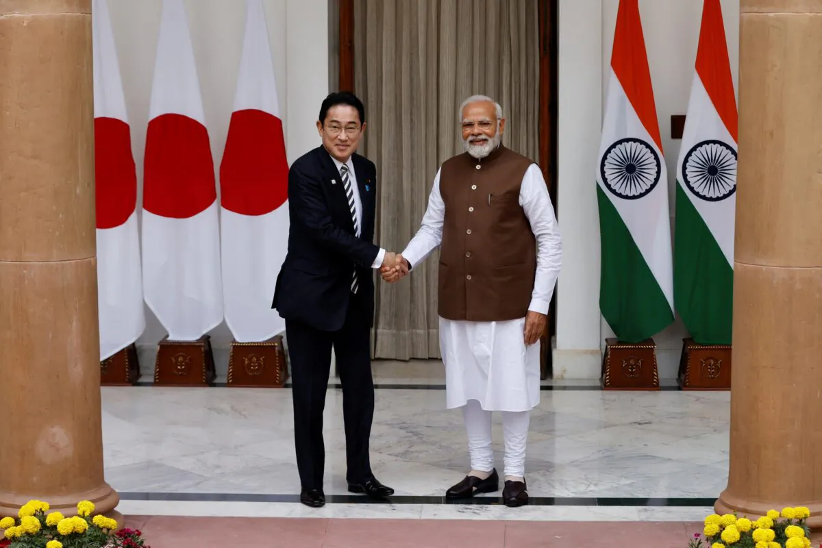 Japan Prime Minister Fumio Kishida (L) shakes hands with his Indian counterpart Narendra Modi before their meeting at the Hyderabad House in New Delhi on March 20, 2023. (Adnan Abidi/Reuters)