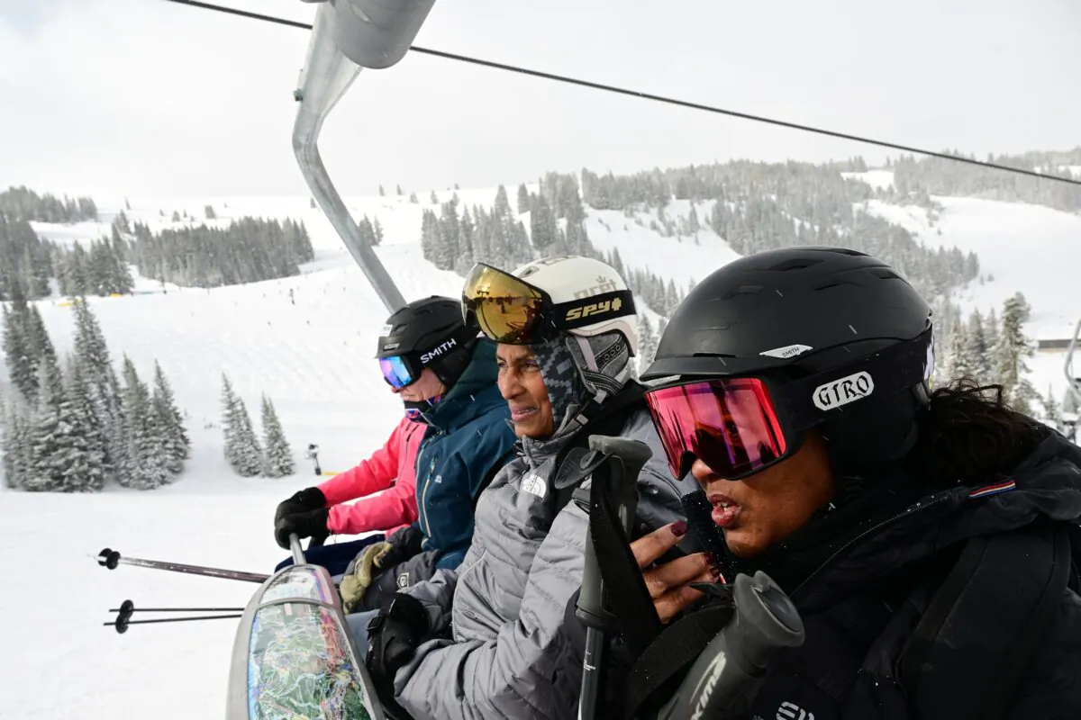 Skier Kim Bailey, right, tries to talk on the phone while she rides the lift with her friend Roxanne Garlington in Vail, Colorado, on Feb. 6, 2023.  (Helen H. Richardson/The Denver Post/TNS)