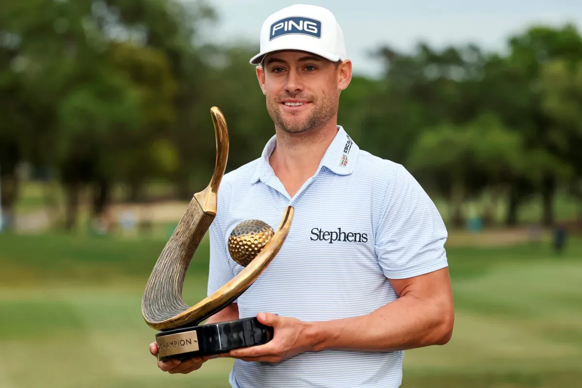 Taylor Moore holds the trophy after winning the Valspar Championship golf tournament at Innisbrook in Palm Harbor, Fla., on March 19, 2023. (Mike Carlson/AP Photo)